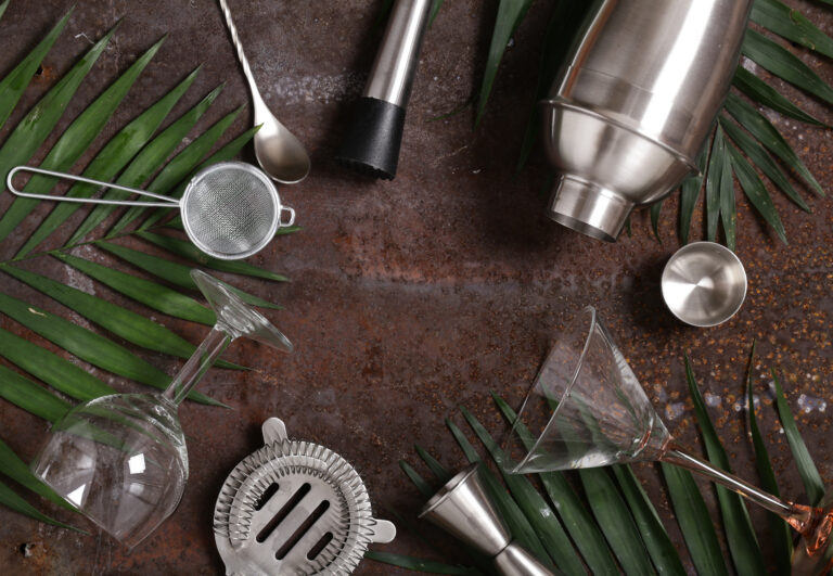 cocktail shaker on the background of fruits and tropical leaves